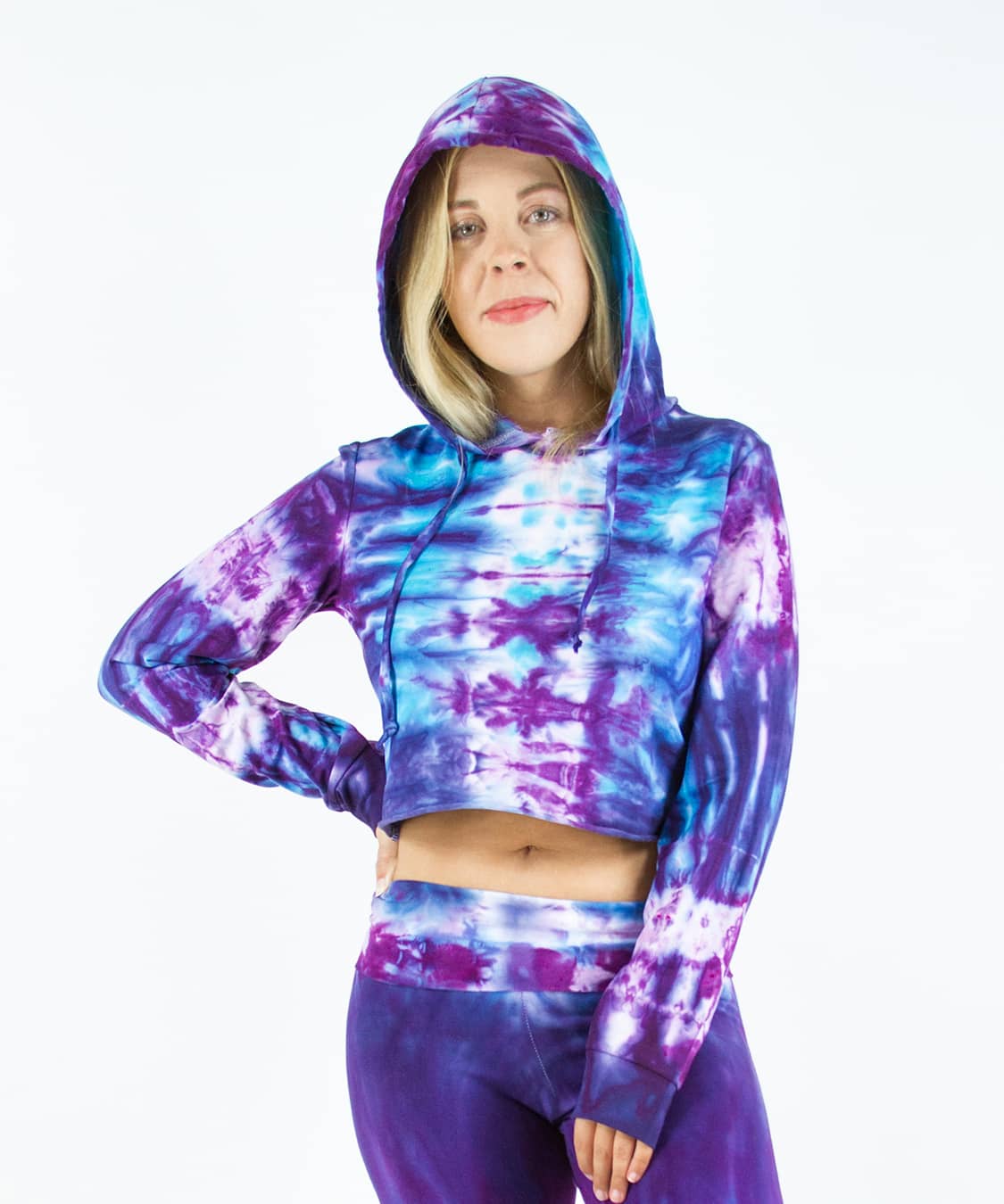 Woman wearing a purple and blue tie dye crop top hoodie by Akasha Sun.