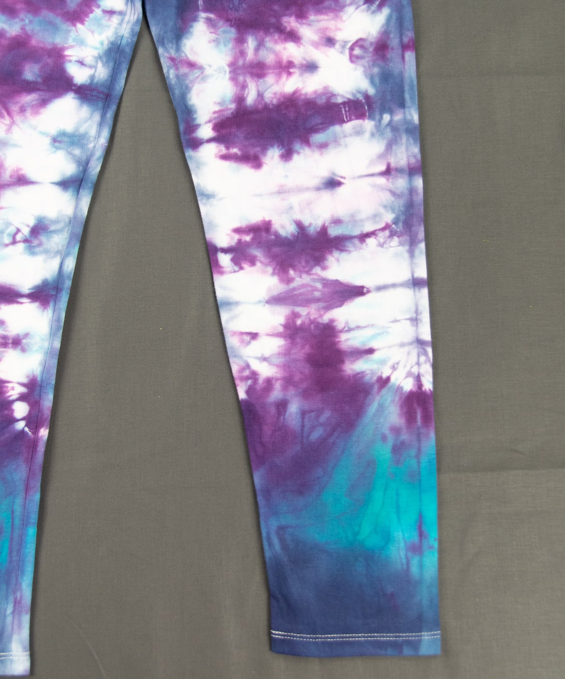 Blue and purple tie dye leggings with wide waistband.