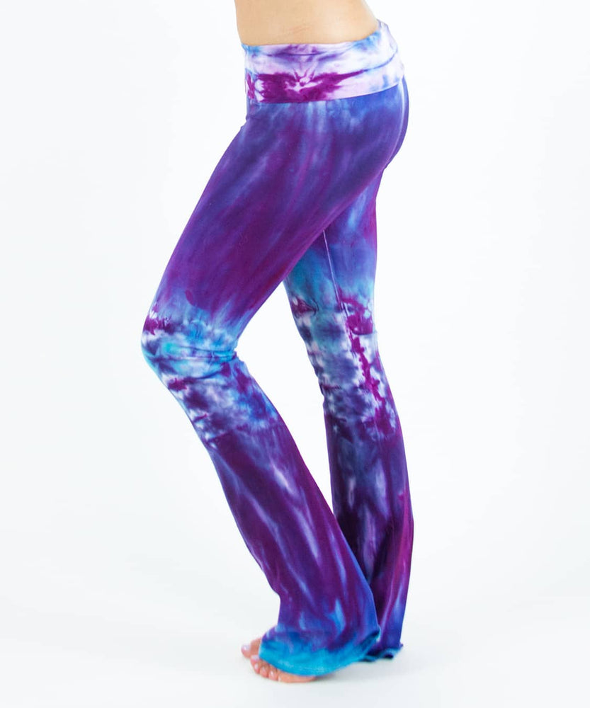 Woman wearing a pair of Akasha Sun tie dye yoga pants in blue and purple.