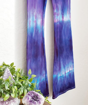 Purple and blue tie dye yoga pants with wide waistband.
