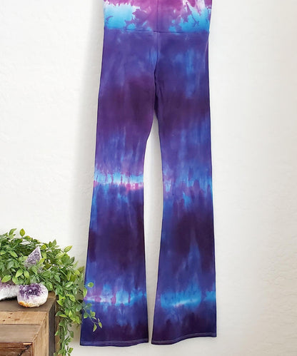 Purple and blue tie dye yoga pants with wide waistband.