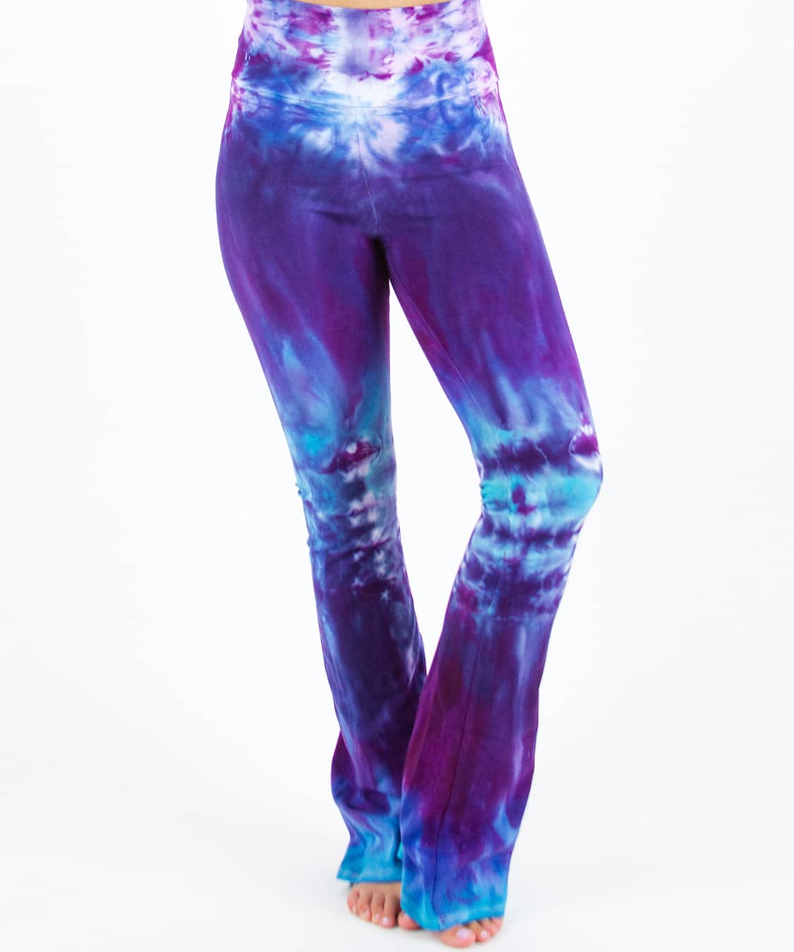 Woman wearing a pair of Akasha Sun tie dye yoga pants in blue and purple.