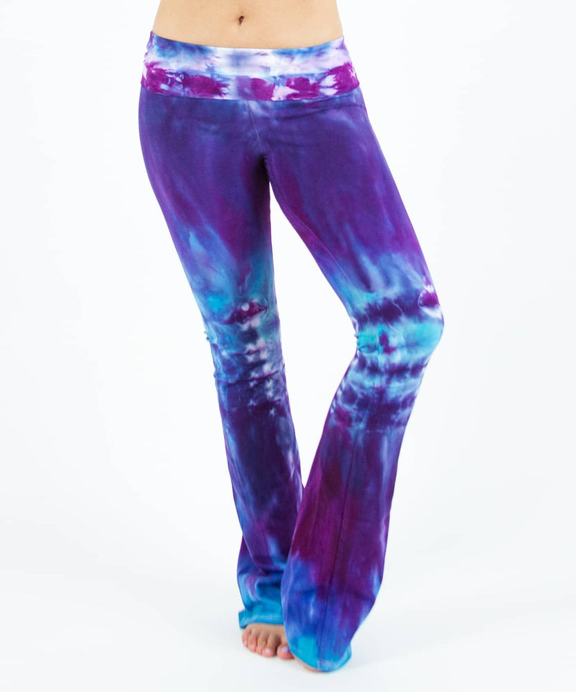 Woman wearing a pair of Akasha Sun tie dye yoga pants in blue and purple.