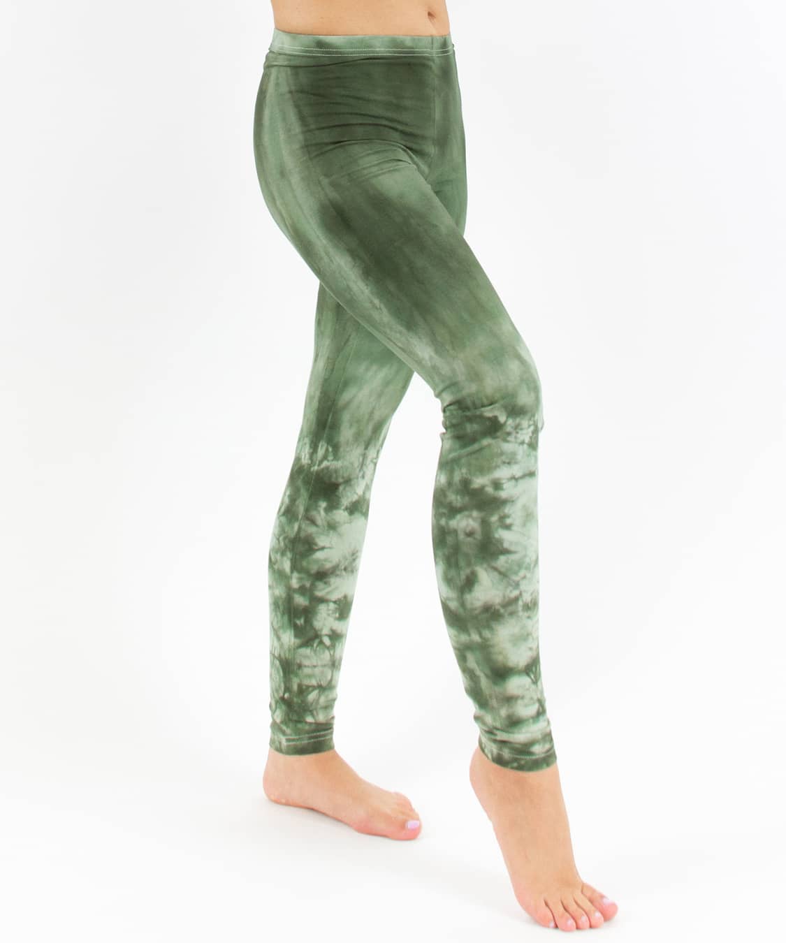 Woman wearing a pair of green tie dye leggings perfect for yoga.