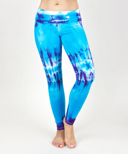 Woman wearing a pair of blue and purple tie dye fold over leggings.  Also can be considered as tie dye maternity leggings.