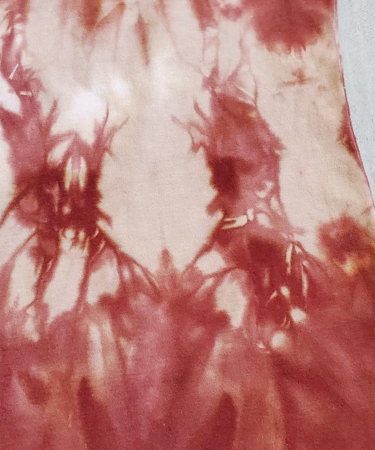 A rust tie dye tank top.