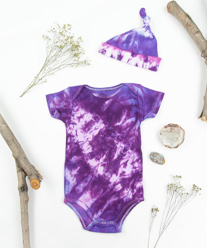 Purple tie dye bodysuit and baby hat set by Akasha Sun.  Made of organic cotton.