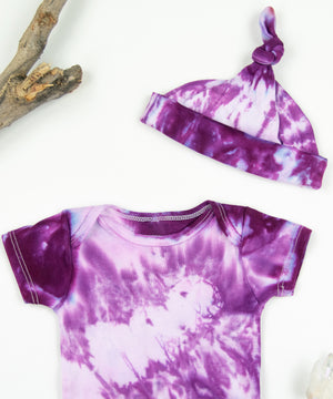 Pink tie dye bodysuit and baby hat set by Akasha Sun.  Made of organic cotton.