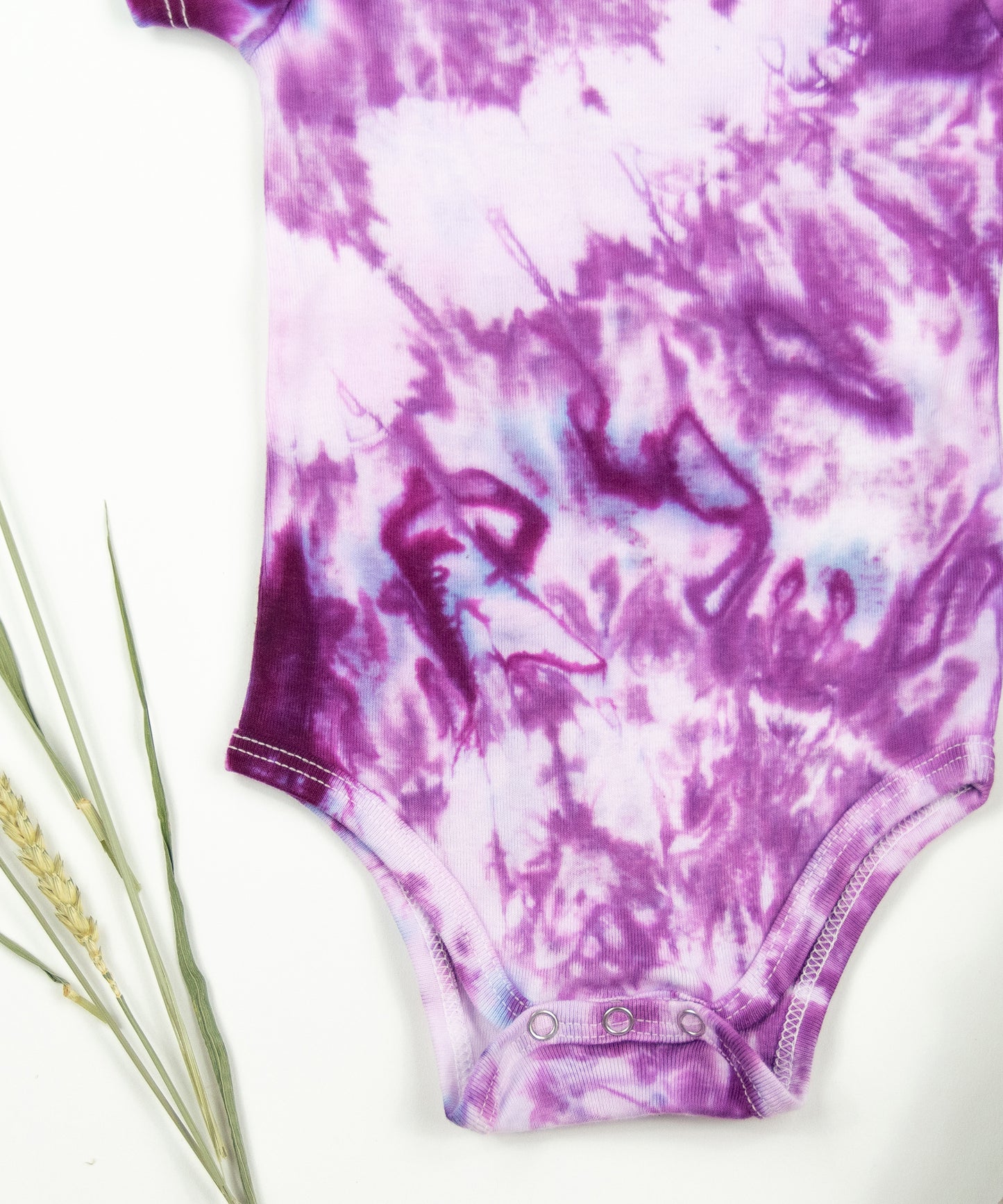 Pink tie dye bodysuit and baby hat set by Akasha Sun.  Made of organic cotton.