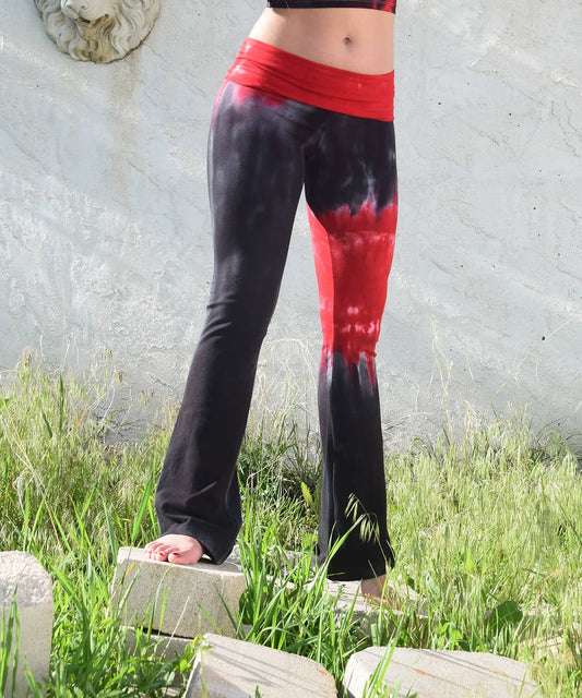 Woman wearing a pair of black and red chakra tie dye yoga pants.