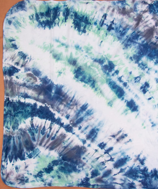 blue, teal, and white tie dye organic baby blanket.
