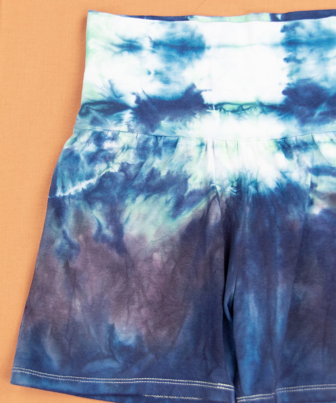 Navy blue and green tie dye shorts with wide waistband.