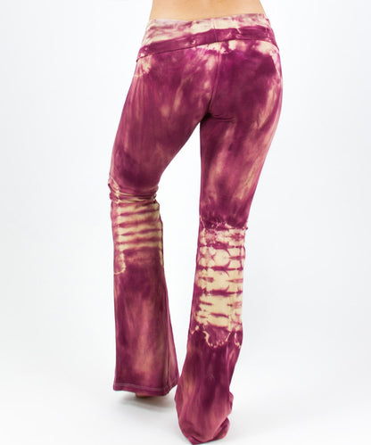 Woman wearing a pair of rose pink tie dye yoga pants with a fold over waistband by Akasha Sun.