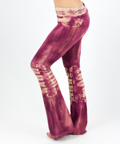 Woman wearing a pair of rose pink tie dye yoga pants with a fold over waistband by Akasha Sun.