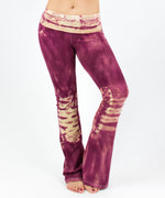 Woman wearing a pair of rose pink tie dye yoga pants with a fold over waistband by Akasha Sun.