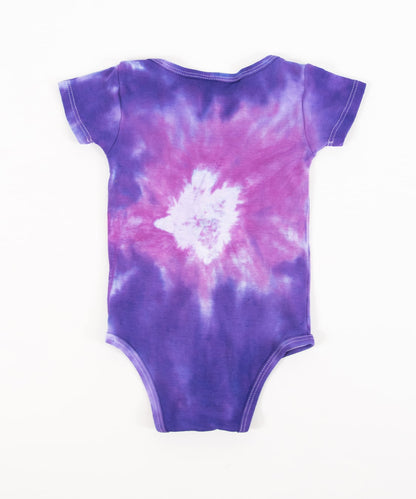 Pink and purple tie dye organic baby set that includes a baby blanket, onesie, and baby hat.