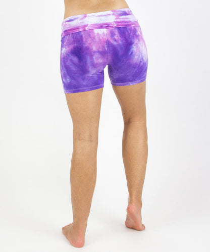 Woman wearing the Saint-Tropez fold over shorts that feature the color purple, pink, and white.