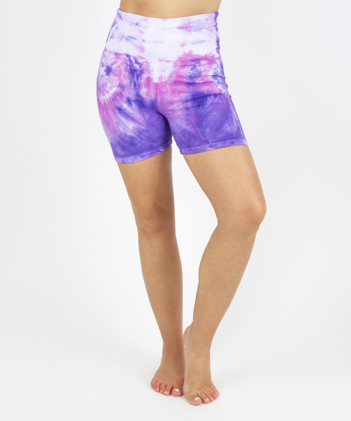 Woman wearing the Saint-Tropez fold over shorts that feature the color purple, pink, and white.