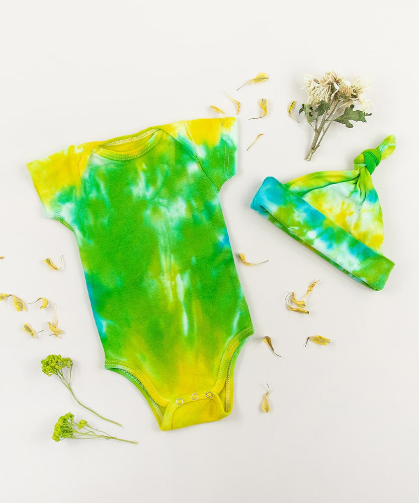 Green, yellow, and blue tie dye organic cotton baby bodysuit and hat set by Akasha Sun.