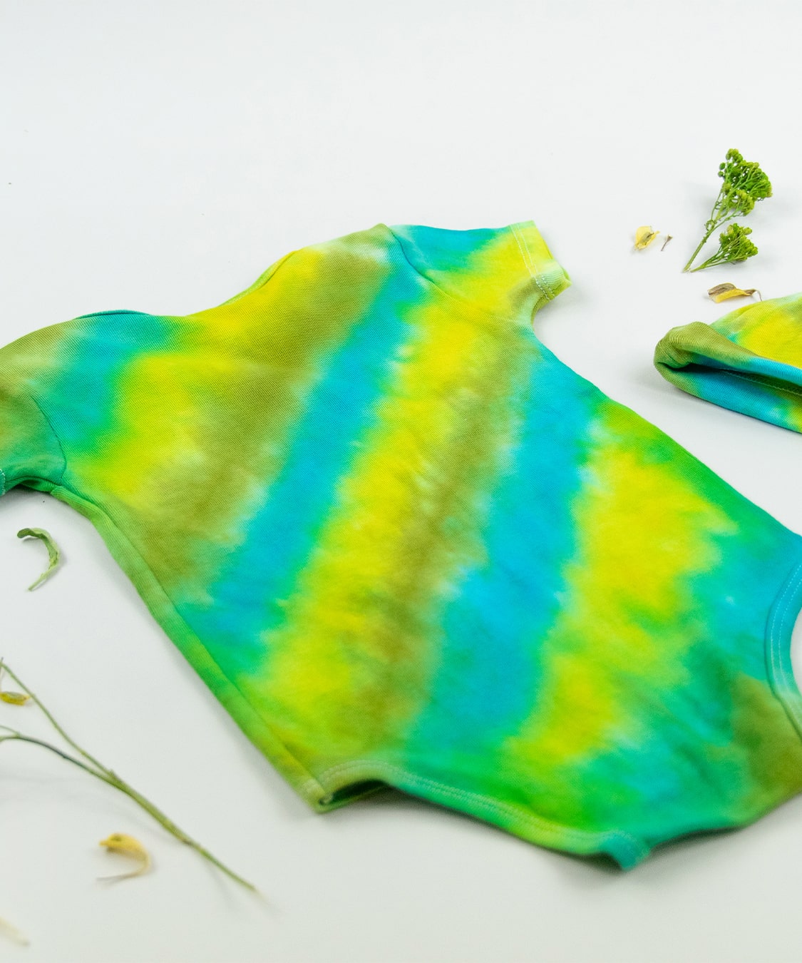 Green and blue tie dye organic cotton baby bodysuit and hat set by Akasha Sun.