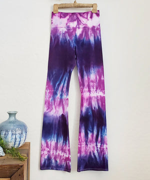 Purple and pink tie dye yoga pants with wide waistband.