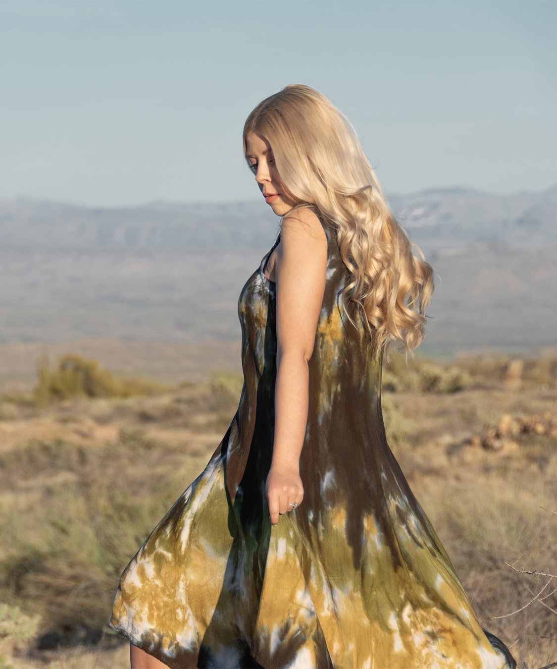 Green, brown, and black tie dye dress by Akasha Sun.