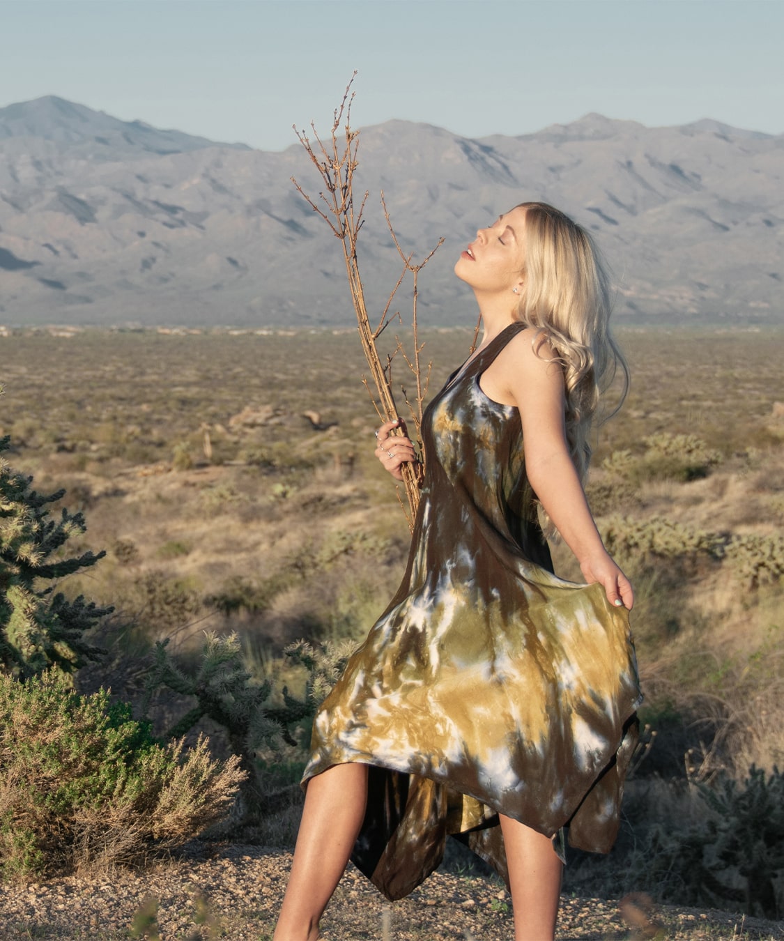 Green, brown, and black tie dye dress by Akasha Sun.