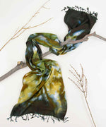 Hand-dyed tie dye scarf in green, yellow, and black by Akasha Sun.