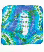 Blue and green tie dye baby gift set that includes an organic cotton baby blanket, baby hat, and onesie.