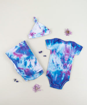 Blue and pink tie dye organic baby bodysuit, baby hat, and blanket set.
