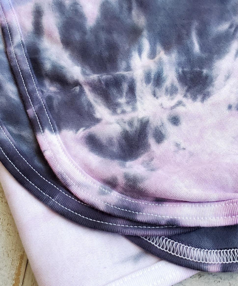 
                
                    Load image into Gallery viewer, A periwinkle and black tie dye organic baby blanket with rounded corners.
                
            