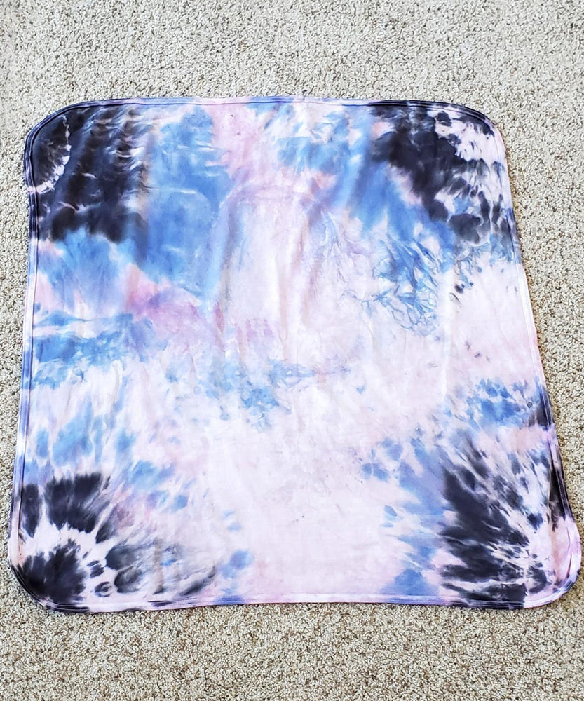 A periwinkle and black tie dye organic baby blanket with rounded corners.