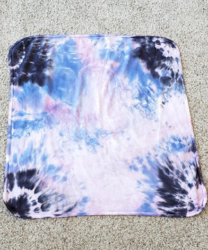 
                
                    Load image into Gallery viewer, A periwinkle and black tie dye organic baby blanket with rounded corners.
                
            