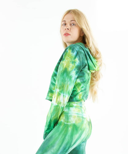 Woman wearing an Akasha Sun green tie dye crop top with a hood.