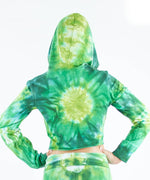 Woman wearing an Akasha Sun green tie dye crop top with a hood.