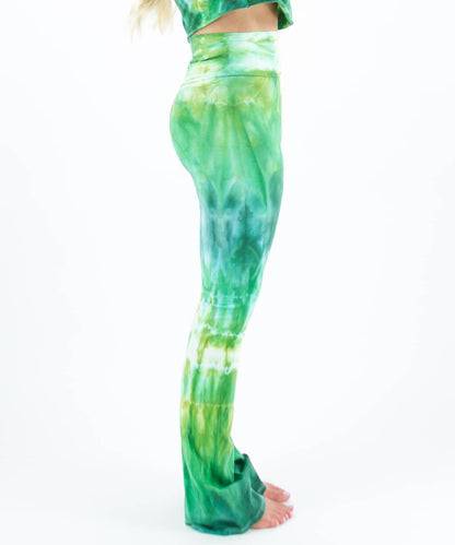 Woman wearing a pair of Akasha Sun fold over green tie dye yoga pants.