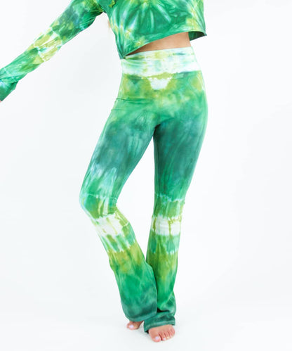 Woman wearing a pair of Akasha Sun fold over green tie dye yoga pants.