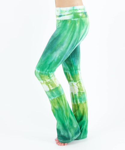 Woman wearing a pair of Akasha Sun fold over green tie dye yoga pants.